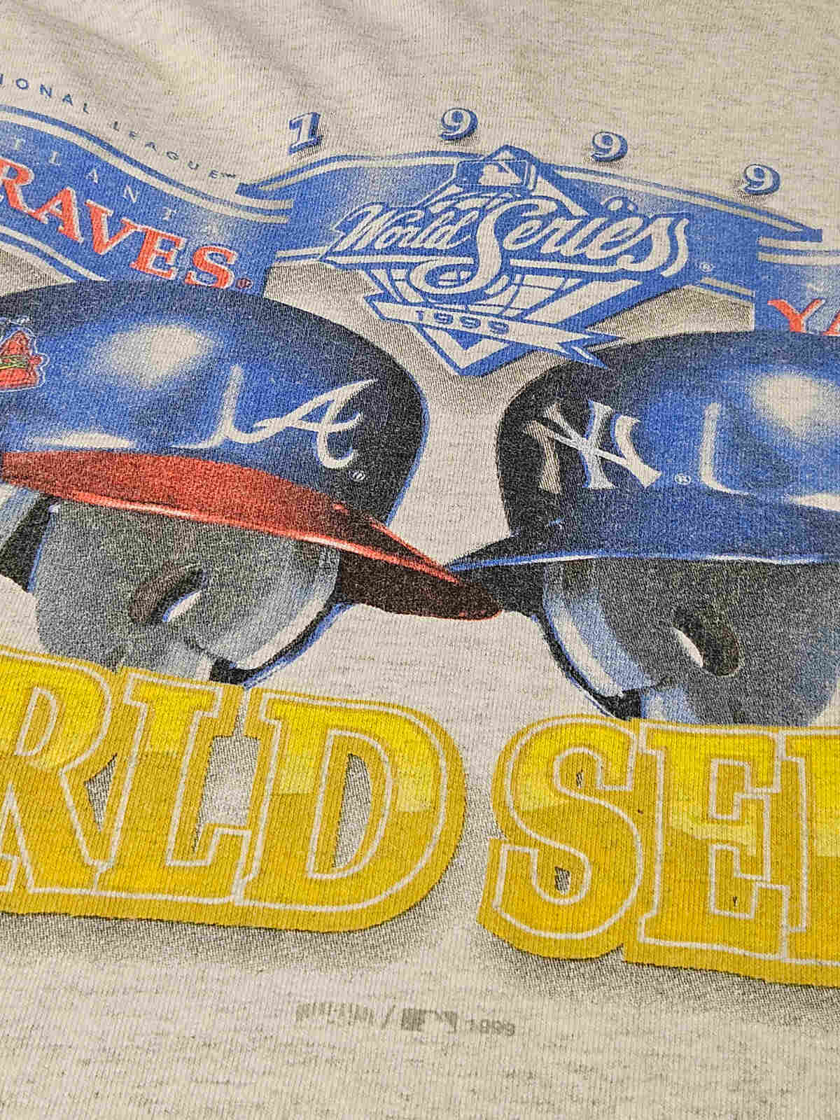 "Close-up van Braves en Yankees helmen op 1999 World Series vintage hoodie T-shirt – originele MLB screen printed graphic met authentieke 90s vibe"

