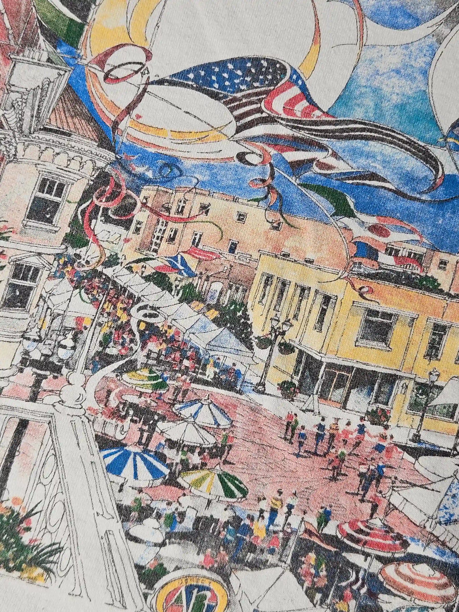 Close-up van Carmel International Arts Festival print – kleurrijke illustratie met luchtballonnen, vlaggen en mensen op een bruisend plein, typisch 90s event merchandise stijl


